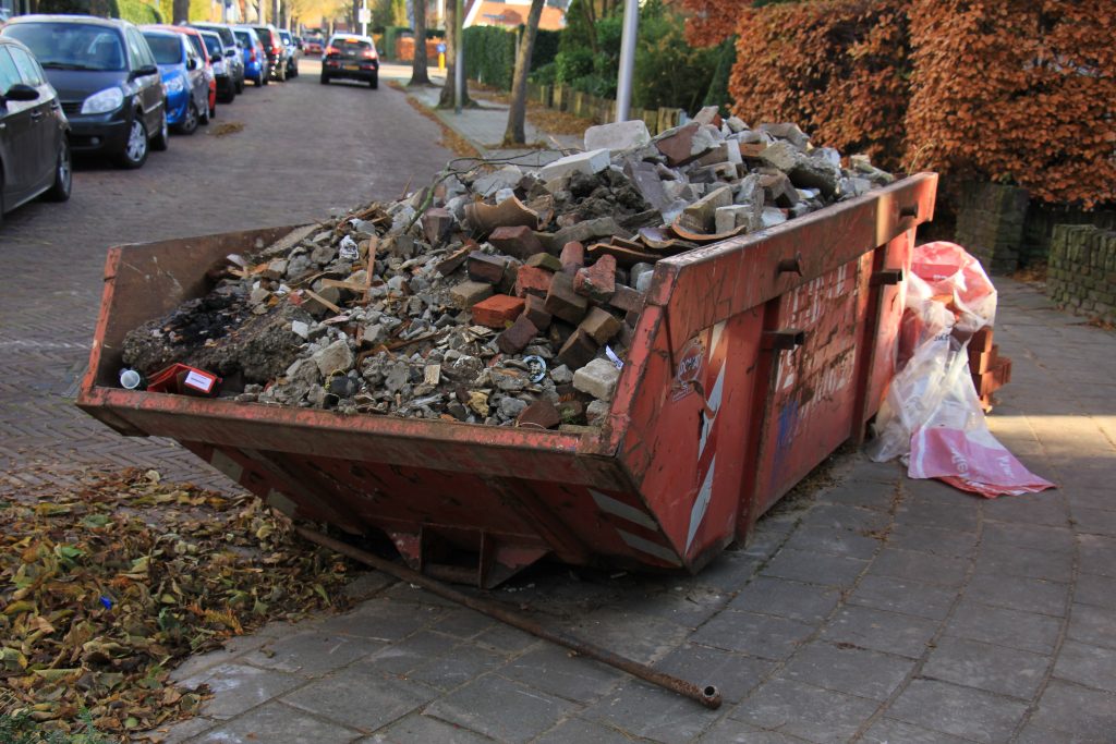 Loaded dumpster near a construction site, home renovation