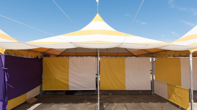 A canopy tent set up outside on a sunny day