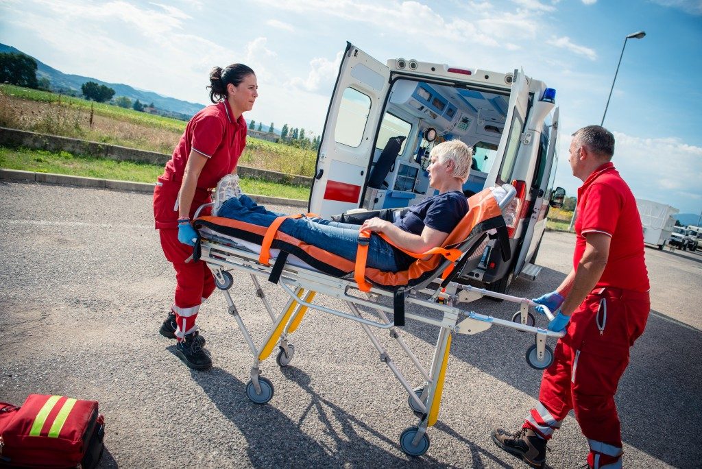 Man being carried inside the ambulance