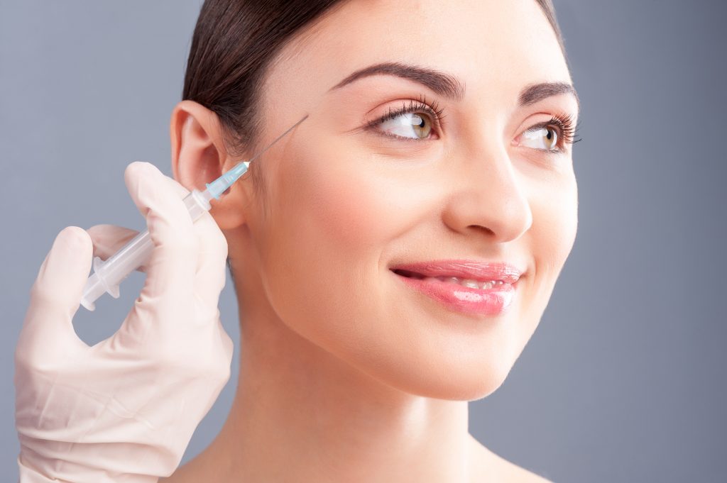Woman receiving facial treatment