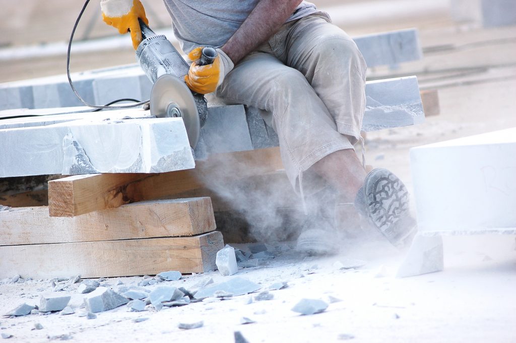 Industrial worker slicing marble