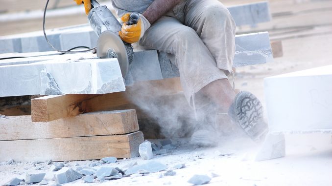 Industrial worker slicing marble