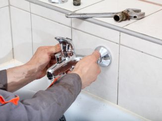 Plumber fixing water tap
