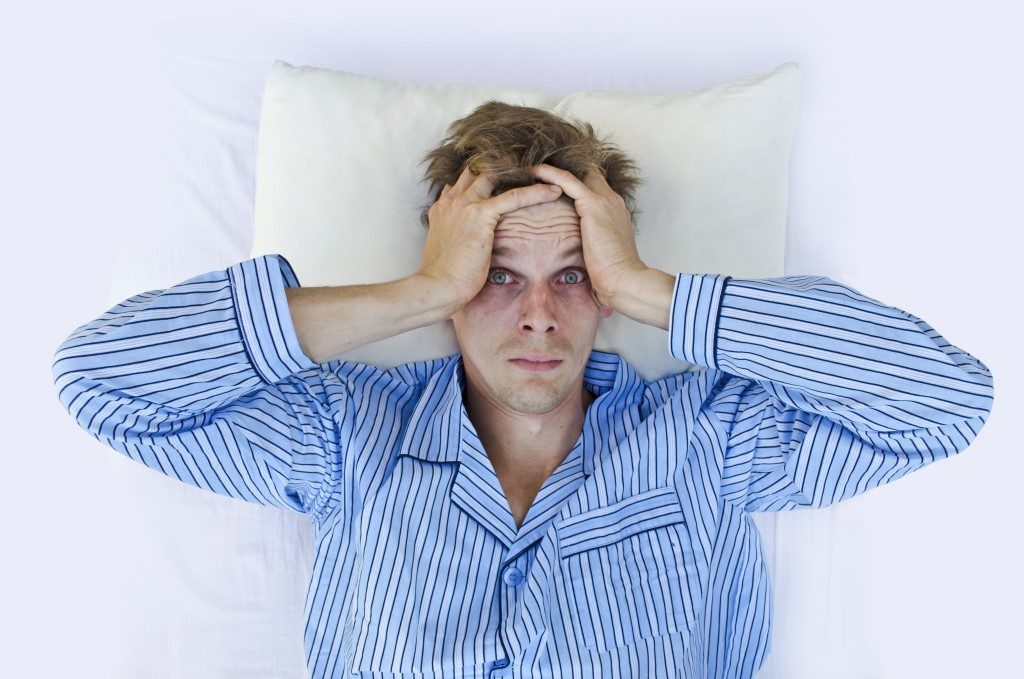 a frustrated man wearing blue pajamas
