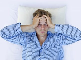 a frustrated man wearing blue pajamas