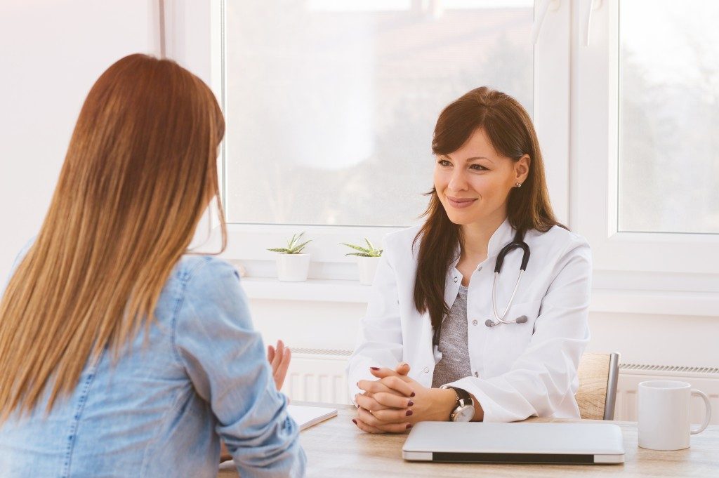 Woman Talking to a Doctor