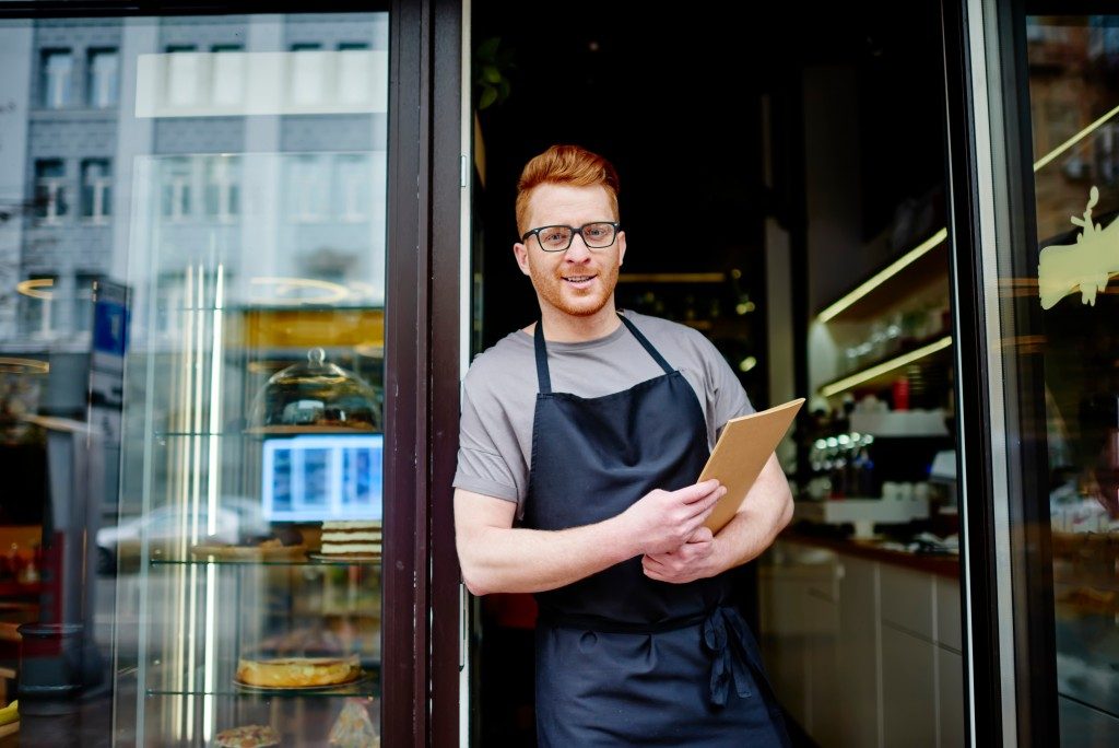 Owner standing in front of his restaurant