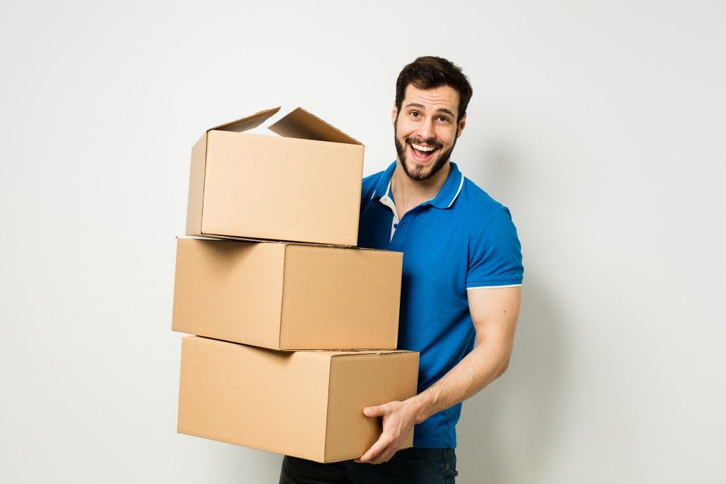 a man carrying boxes