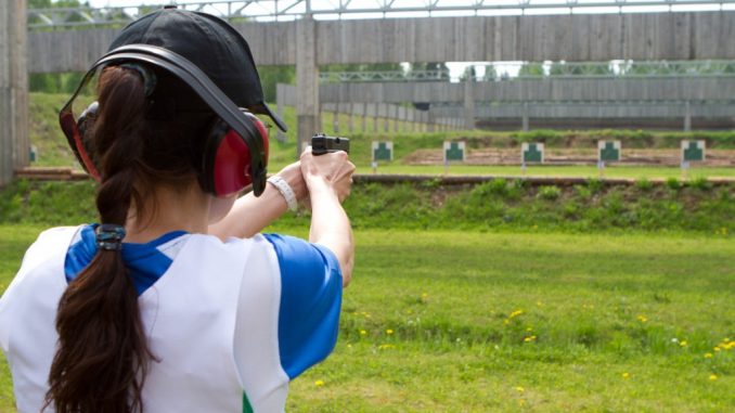 Woman practicing in the shooting range