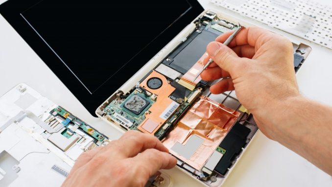 The engineer repairs the laptop (pc, computer) and the motherboard. Installs the equipment (cpu)
