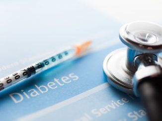 Stethoscope and a syringe on a diabetes test