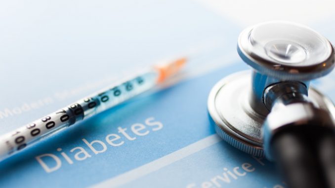 Stethoscope and a syringe on a diabetes test