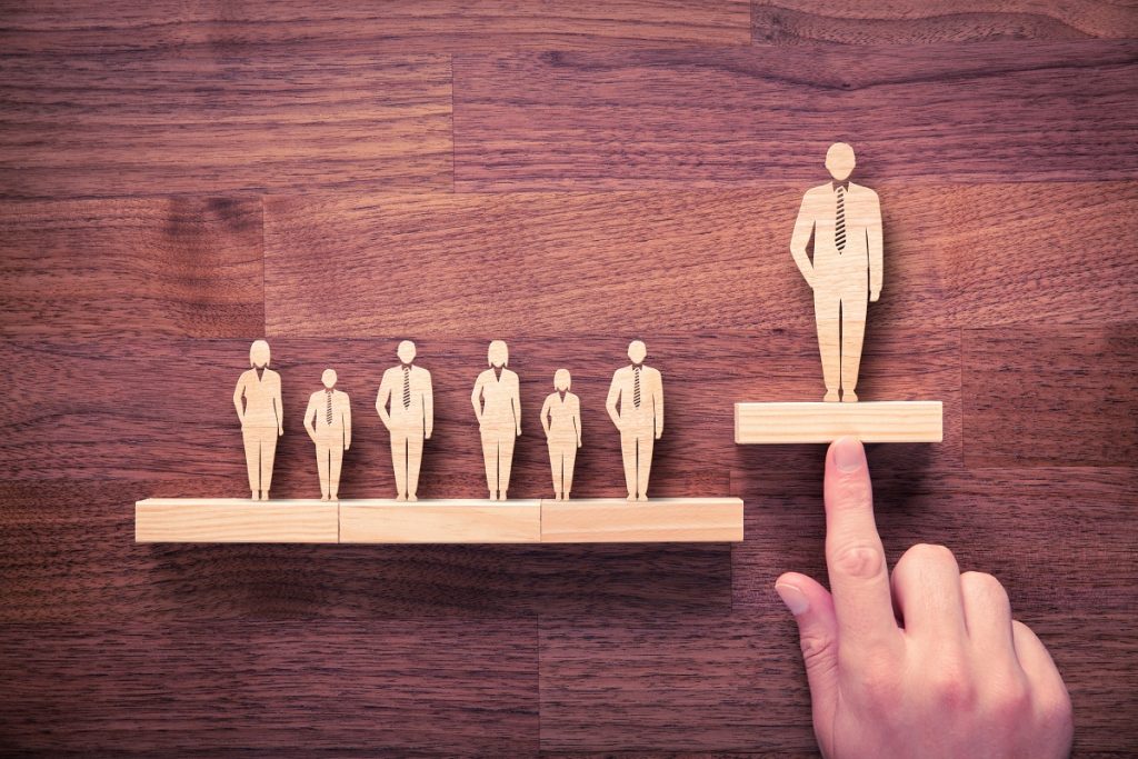 wooden people icon miniature in a wooden background