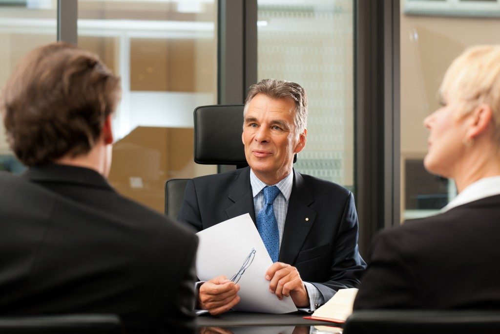 people meeting in front of a lawyer