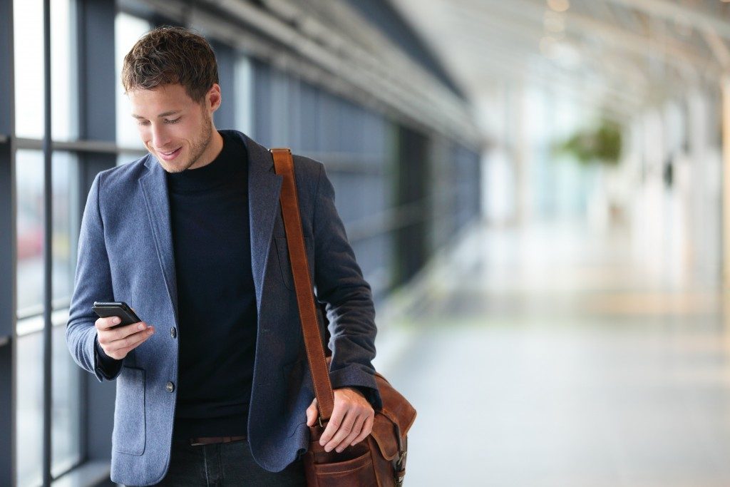businessman on a phone walking inside the airport