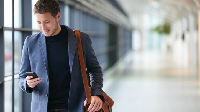 businessman on a phone walking inside the airport