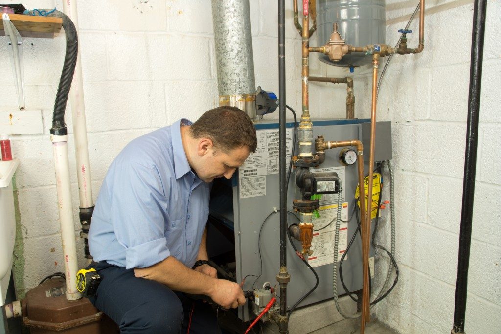 plumber fixing a gas pipe