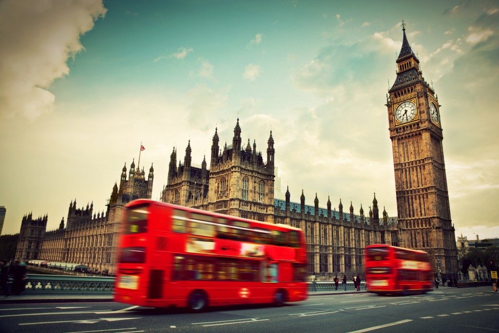 Red bus in motion and Big Ben