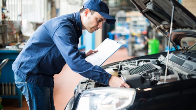 man working on a car's engine bay