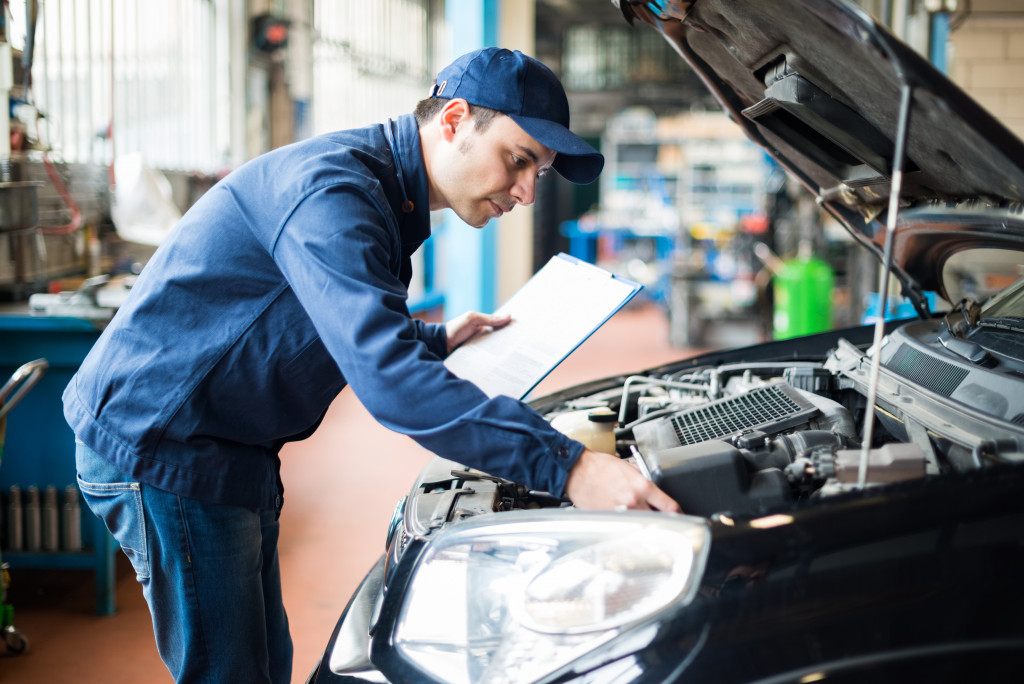 man working on a car's engine bay