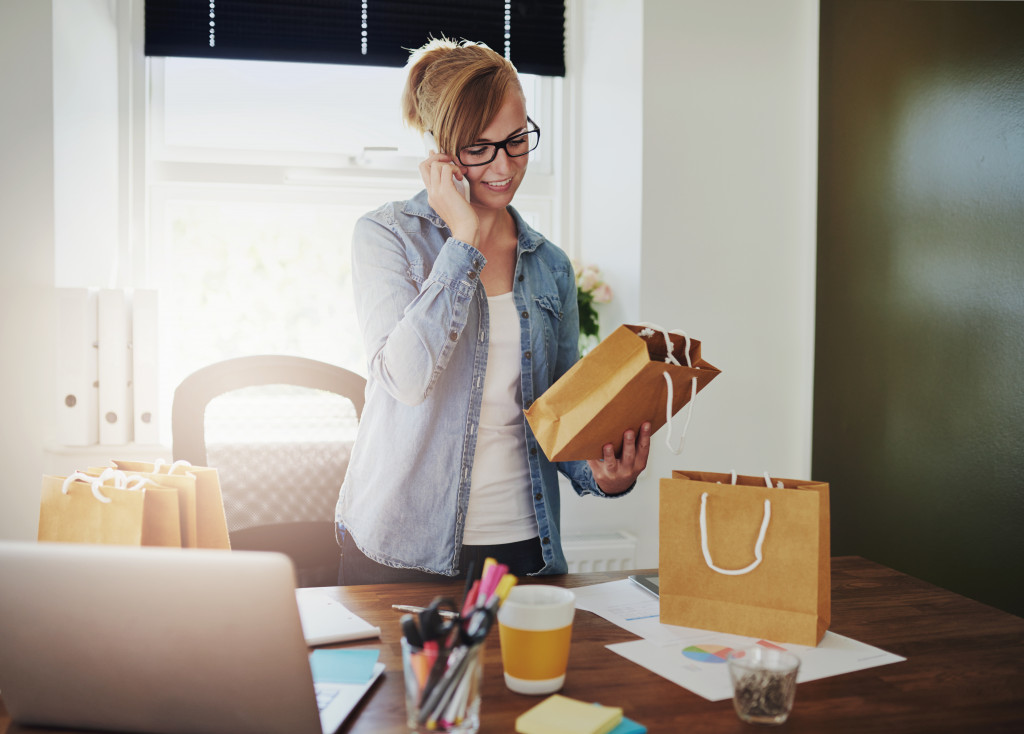 woman on phone with products